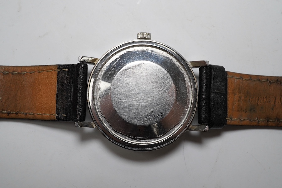 A gentleman's stainless steel Longines Conquest Automatic wrist watch, on an associated leather strap, case diameter 35mm. Condition - poor to fair